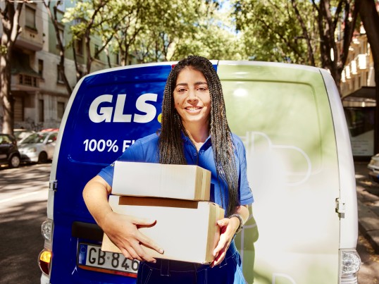GLS courier in front of GLS van